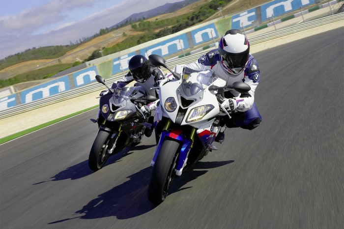 Two BMW S1000RR motorcycles on a race track