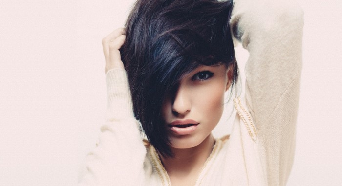 Woman with dark hair and light sweater
