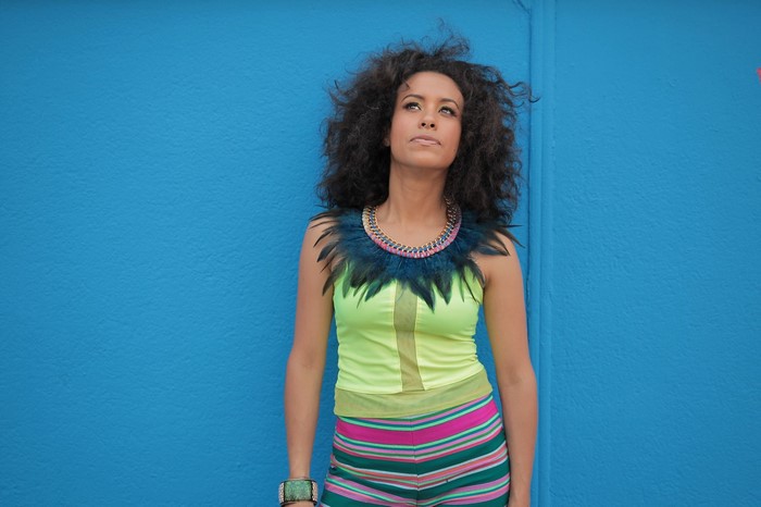 La Yegros posing against a blue wall