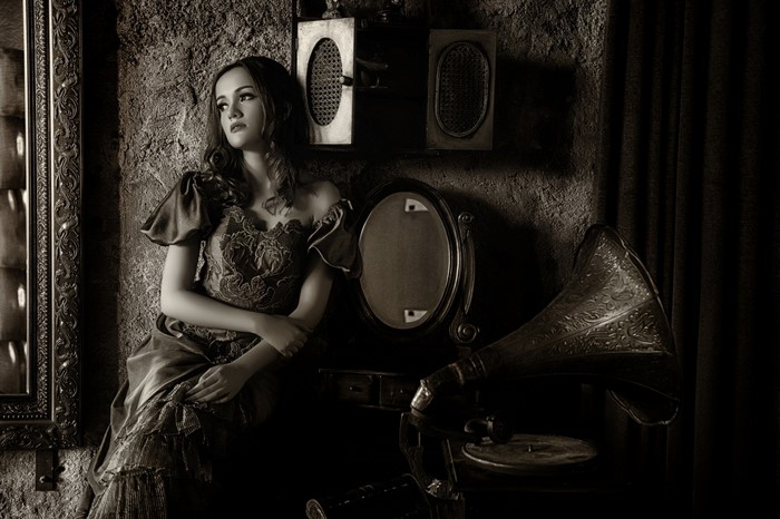 Woman in vintage dress with gramophone and mirror