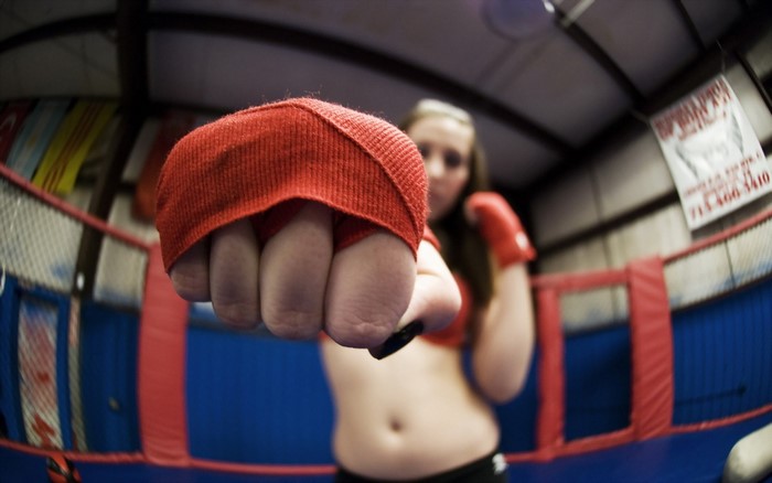 Woman in boxing gloves in a ring