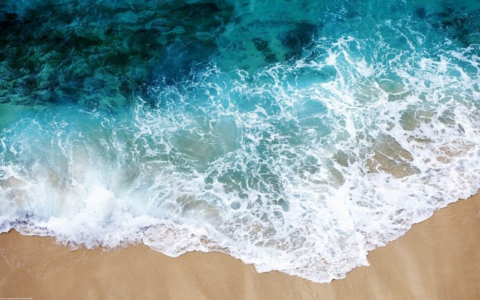 Ocean waves crashing on a sandy beach
