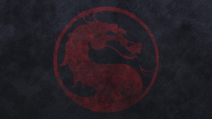 Mortal Kombat logo on a dark textured surface