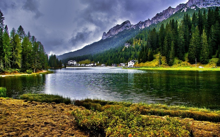 Lake with mountains and forest in the background