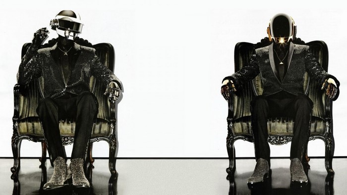 Daft Punk robots sitting on chairs