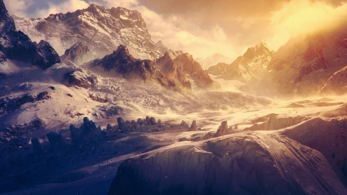 Snowy mountain range with sunlight and mist
