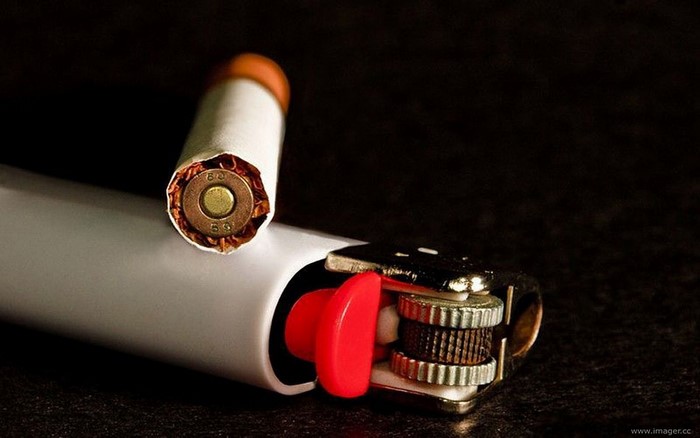 Cigarette with bullet inside and a lighter