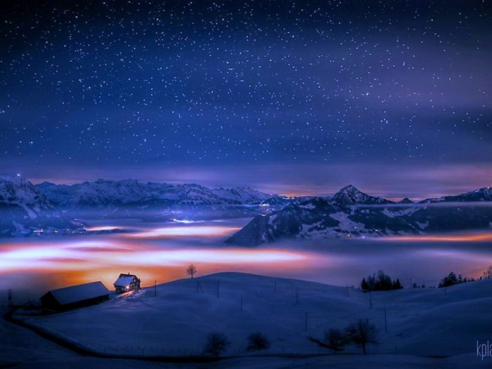 Snowy mountains under a starry night sky