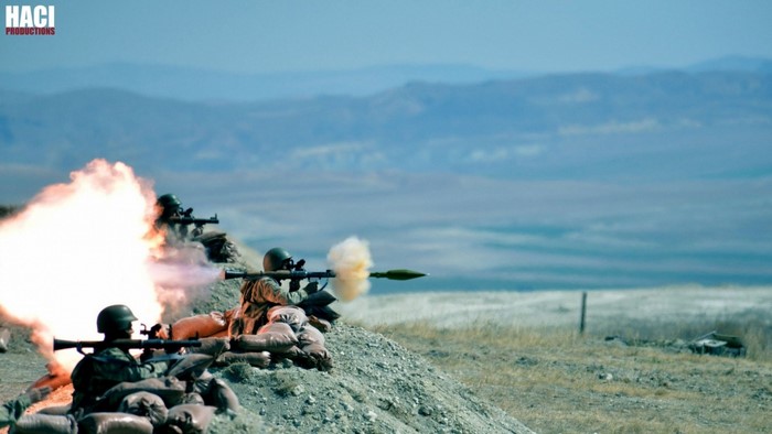 Soldiers firing RPGs from sandbag fortifications