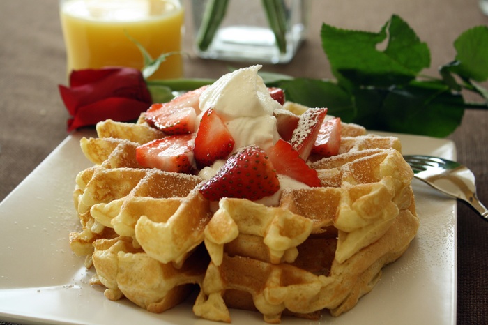 Waffles with strawberries and whipped cream