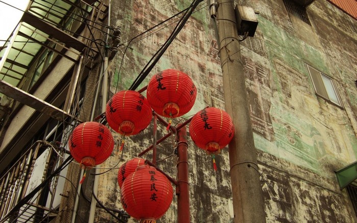 Red lanterns hanging in front of an old building