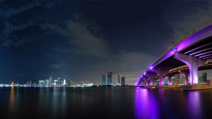 Miami Beach cityscape at night with illuminated bridge