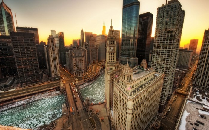 Chicago cityscape with frozen river at sunset