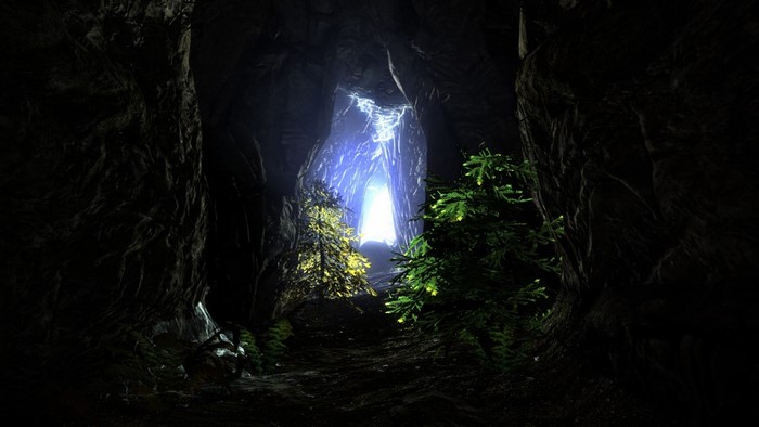 Cave entrance with glowing light and trees