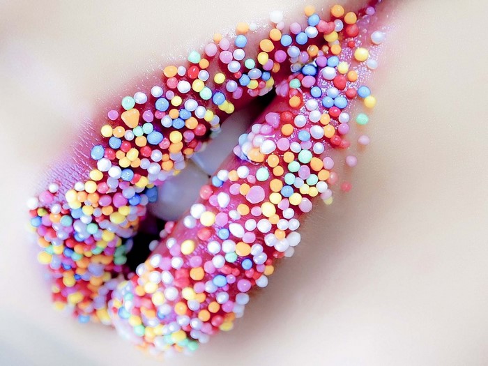 Lips decorated with colorful candy sprinkles