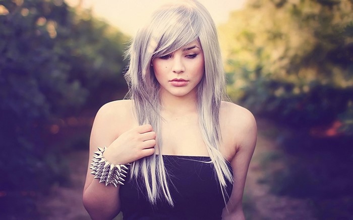 Woman with white hair and spiked bracelet