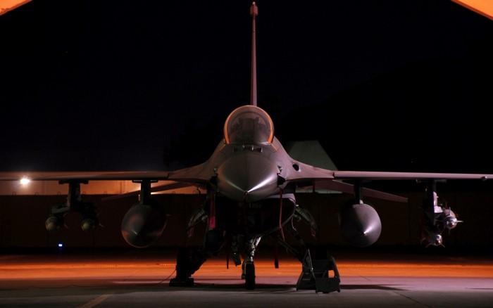 F-16 Fighting Falcon military aircraft at night