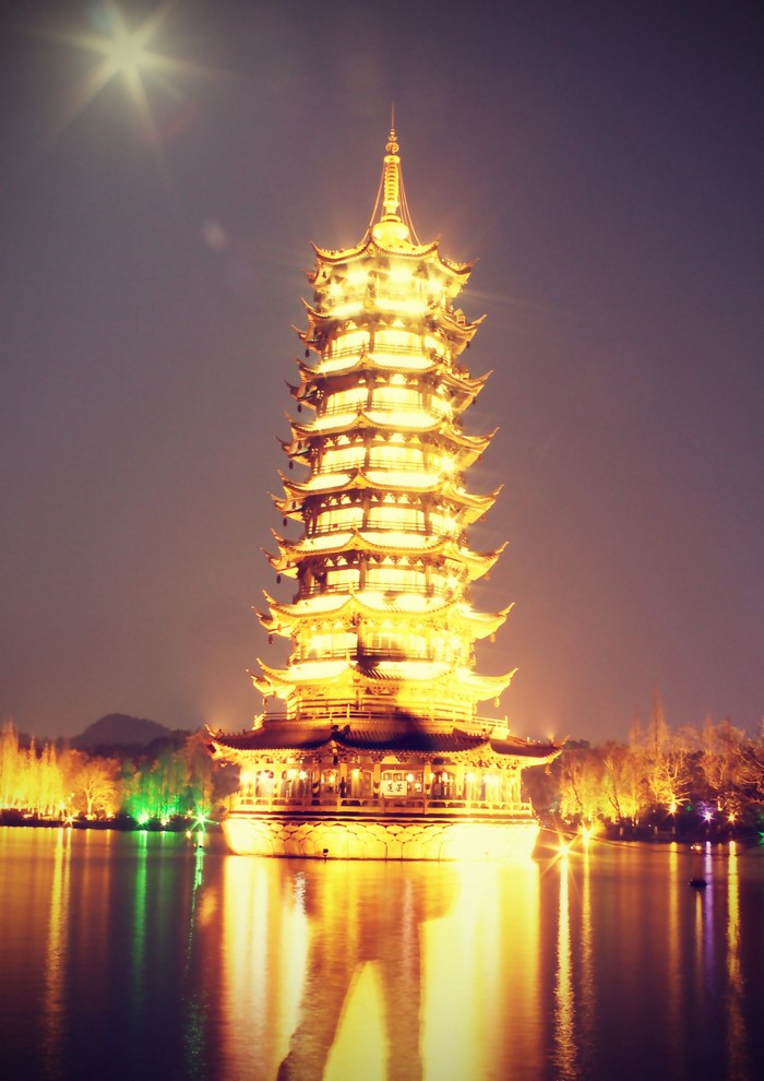 Pagoda illuminated at night on a lake in Guilin
