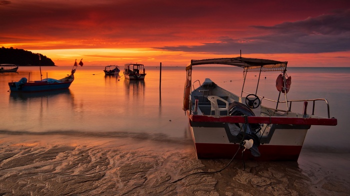 Boats on the water at sunset