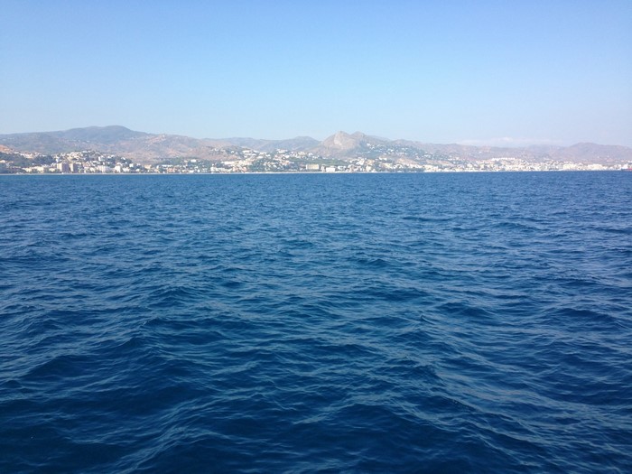 Ocean view with coastal city and mountains