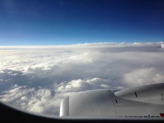 Norwegian airplane engine flying above clouds