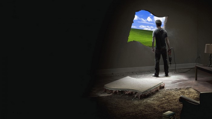 Man breaks hole in wall to reveal Windows XP landscape