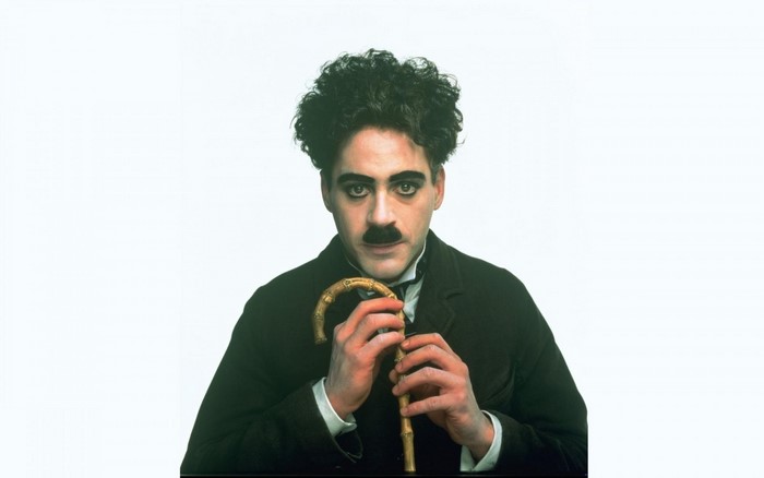 Robert Downey Jr. as Charlie Chaplin with cane