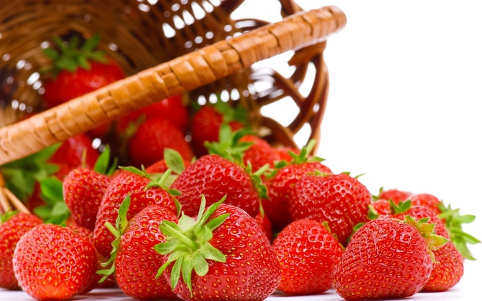 Strawberries spilling from a basket