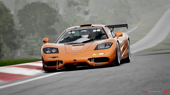 Orange McLaren F1 race car on track