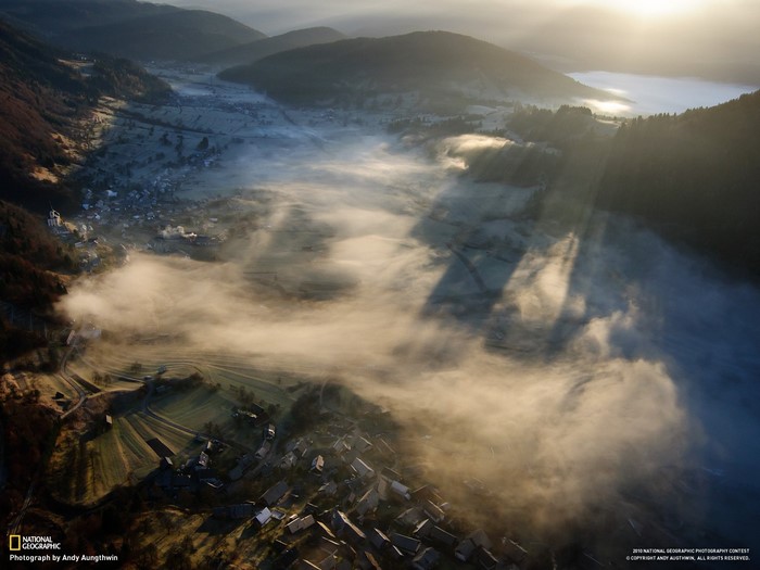 Aerial view of a misty valley at sunrise