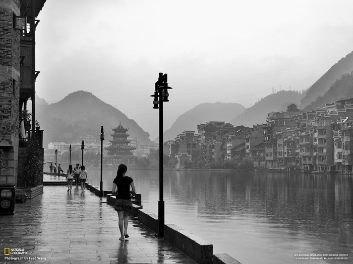 Monochrome cityscape with river and mountains