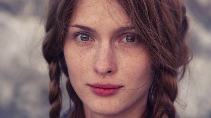 Portrait of Woman with Freckles and Braided Hair