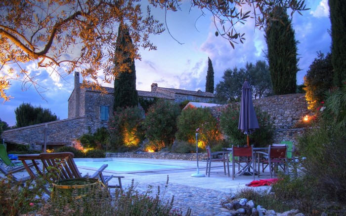 Estate with swimming pool and garden at dusk