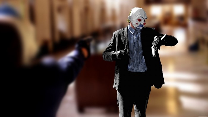 The Joker from The Dark Knight holding a gun