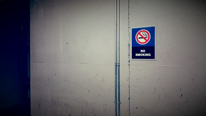 No Smoking Sign on Concrete Wall