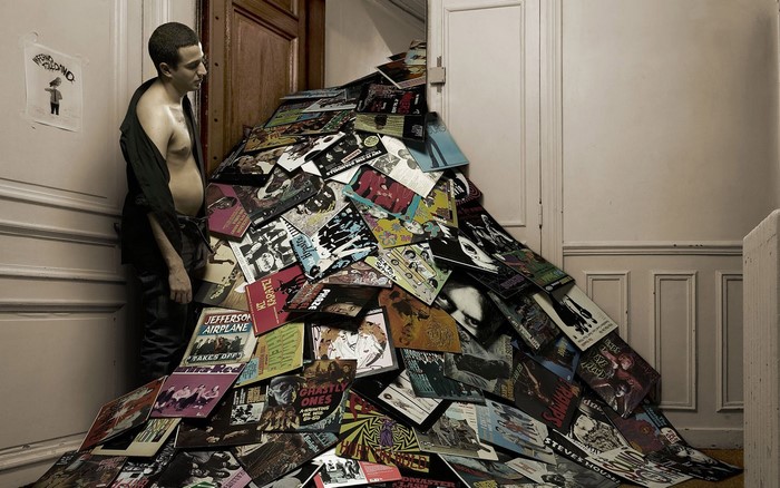 Man with a pile of vinyl records