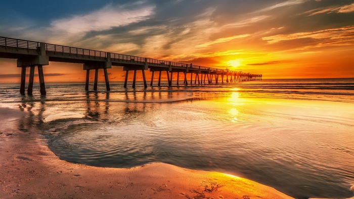 Pier over the ocean at sunset
