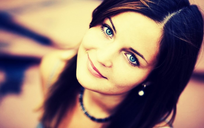 Close-up portrait of a woman with blue eyes and a smile