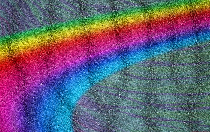 Rainbow light on textured green surface