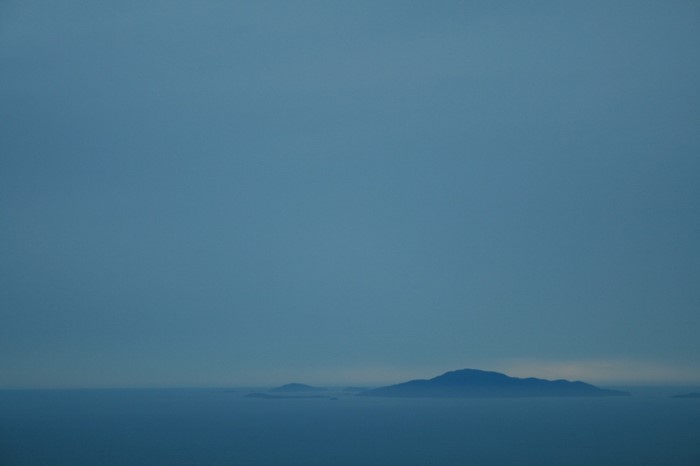 Islands on the horizon at dusk over the sea