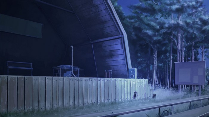 Outdoor stage at night with piano and equipment