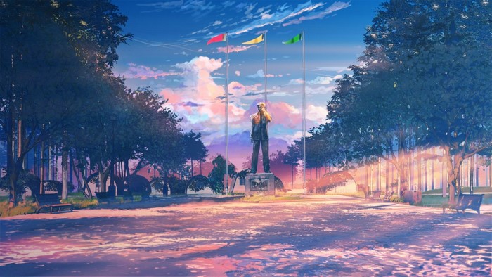 Statue in a park with flags at sunset