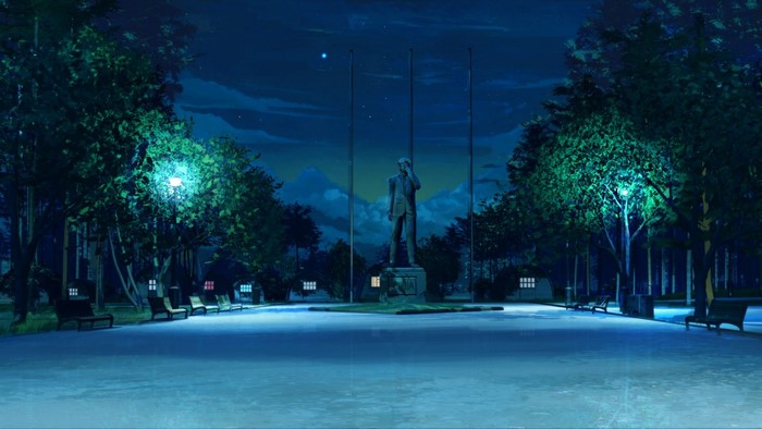Statue in a park at night with streetlights