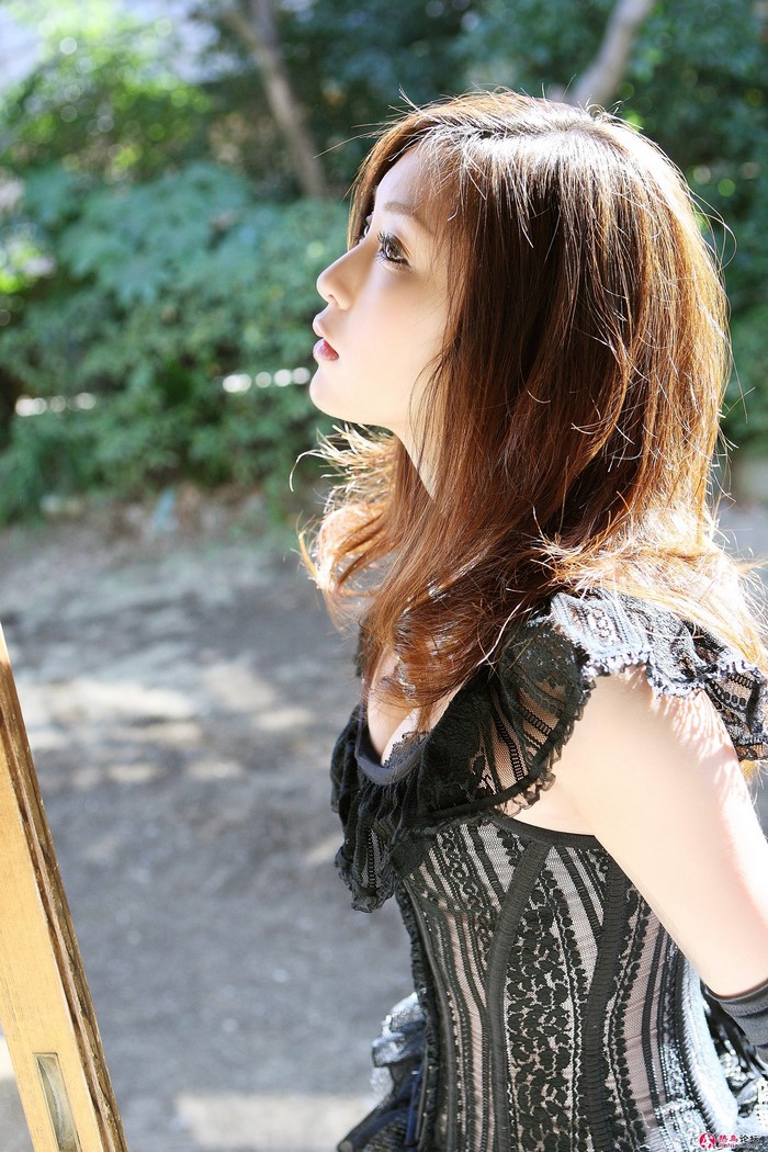 Natsuko Tatsumi in a black lace dress outdoors