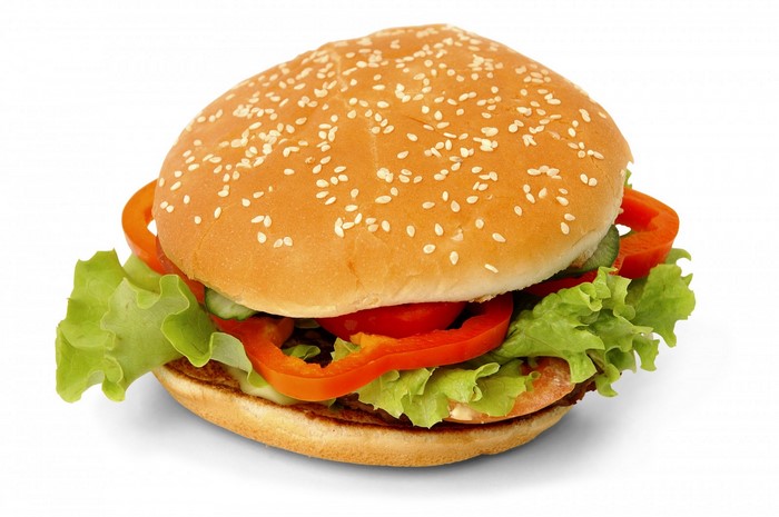 Hamburger with lettuce, tomato, and red pepper on a sesame seed bun
