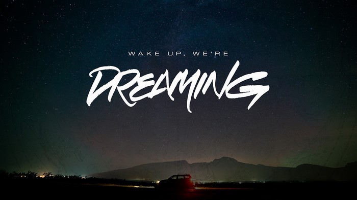 Wake Up, We're Dreaming text over starry night sky