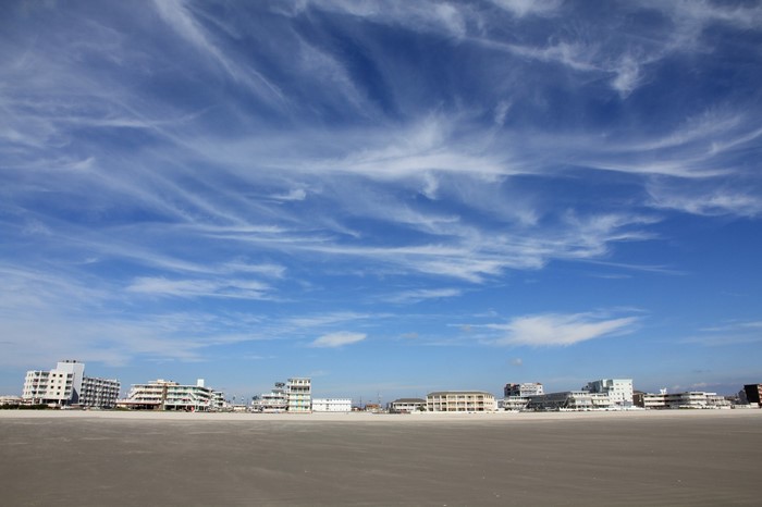 Beachfront buildings under a cloudy sky