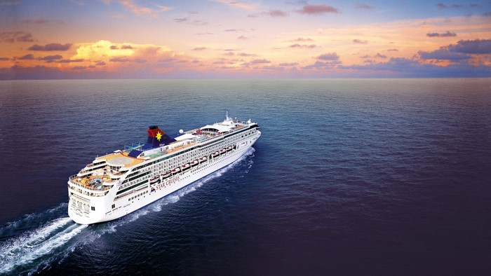 Star Cruises ship sailing on the ocean at sunset