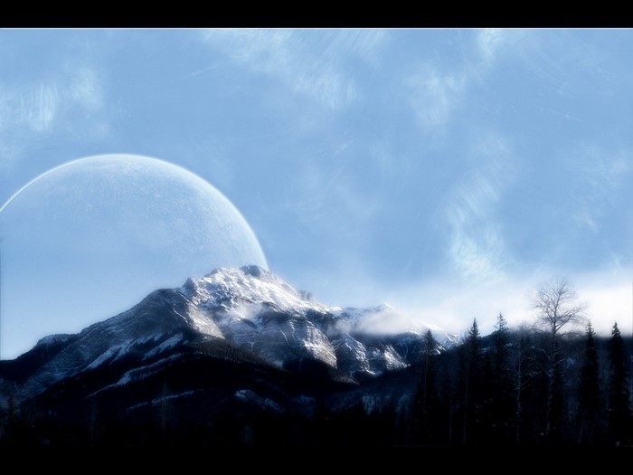 Snowy mountain range with a large moon in the sky