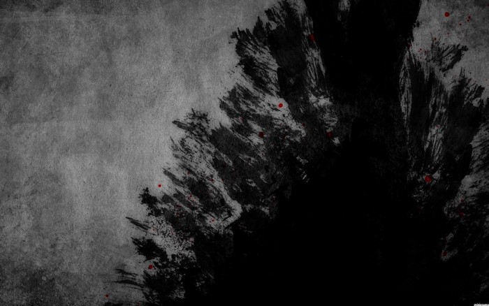 Abstract black ink splatters on textured gray background